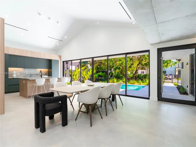 a dining room with furniture and a floor to ceiling window