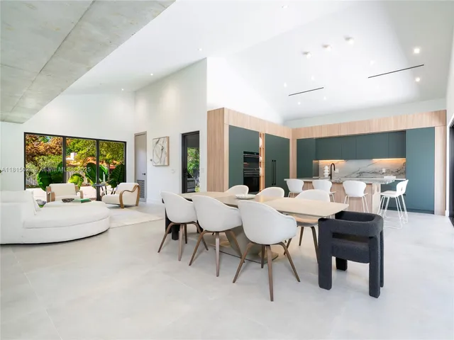 a view of a dining room with furniture and a potted plant