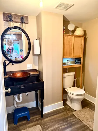 a bathroom with a toilet a sink and a mirror