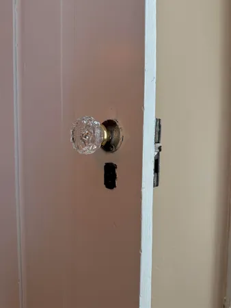 a view of a bedroom with baby bed and closet