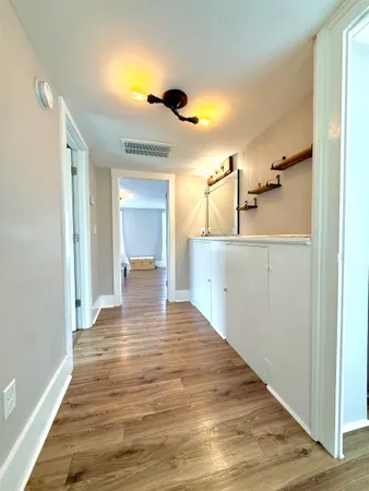 a bathroom with a sink a toilet and a window