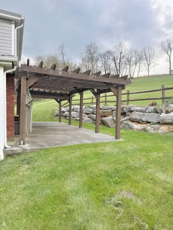 a view of a house with a yard and sitting area