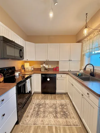 a kitchen with granite countertop wooden cabinets and stainless steel appliances