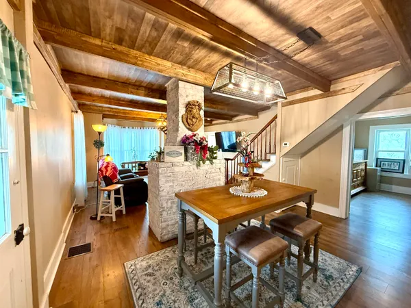 a dining room with furniture and wooden floor