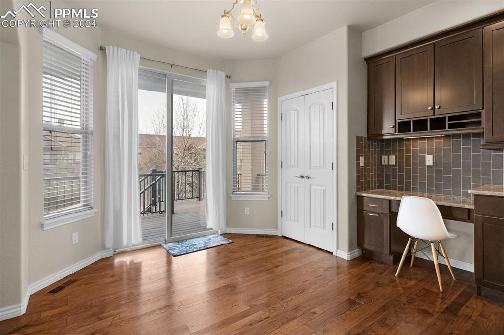 1053 Crystal Basin Drive Colorado Springs, CO 80921 - Photo 16 of 49 an empty room with wooden floor and a bathroom