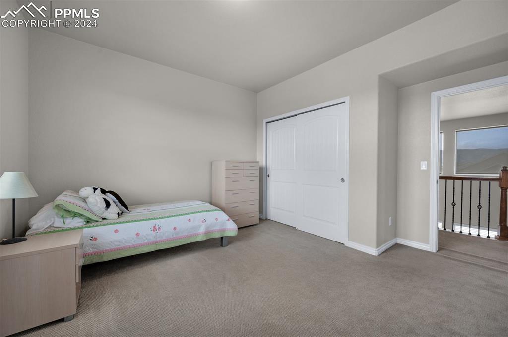 1053 Crystal Basin Drive Colorado Springs, CO 80921 - Photo 31 of 49 a bedroom with a bed and a window