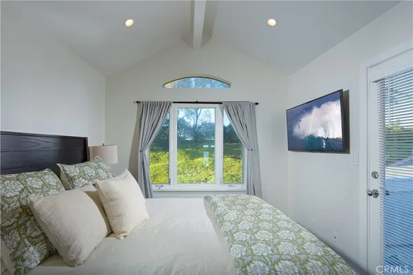 a bedroom with a bed and a large window