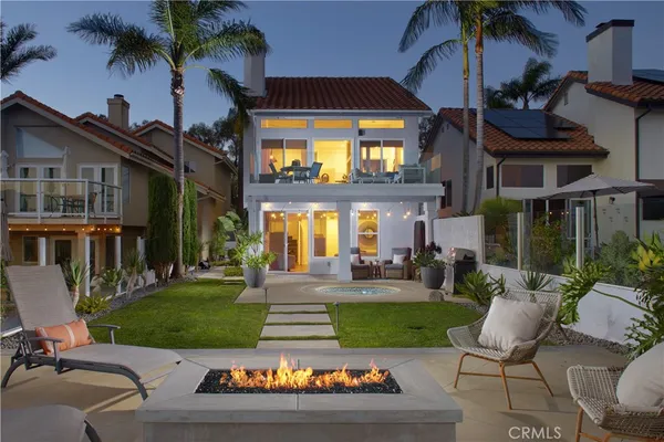 a view of a house with backyard porch and sitting area
