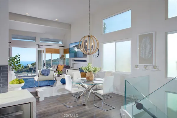 a living room with patio furniture and a potted plant