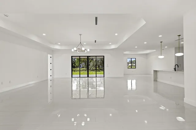 a kitchen with white cabinets and sink