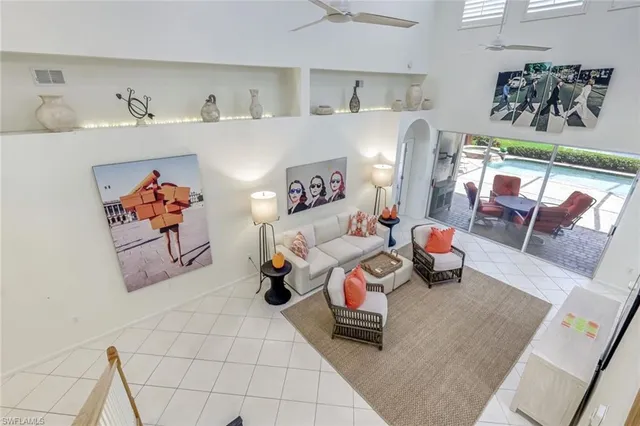 a living room with furniture and painting on the wall