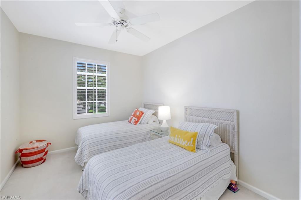 23045 Tree Crest Court Estero, FL 34135 - Photo 26 of 46 Guest bedroom featuring plantation shutters, plush carpeting, baseboards and ceiling fan