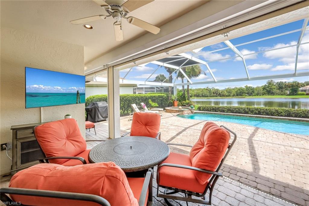 23045 Tree Crest Court Estero, FL 34135 - Photo 30 of 46 Step out onto your covered lanai space, equipped with electric hurricane shutters