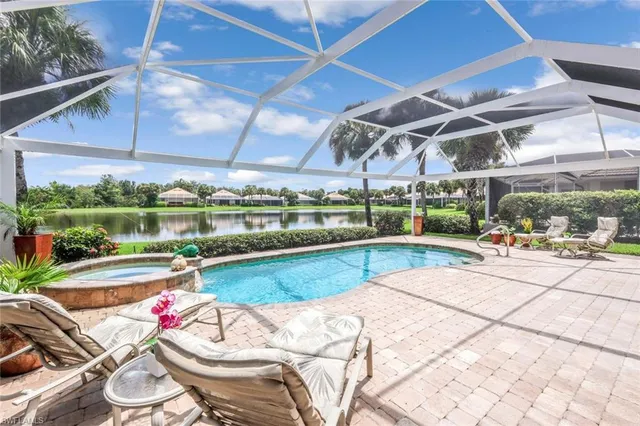 a view of a swimming pool and outdoor seating