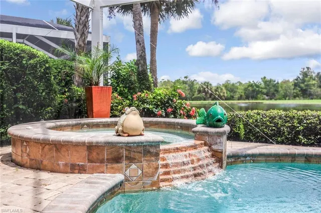 a view of a fountain in the backyard of a house