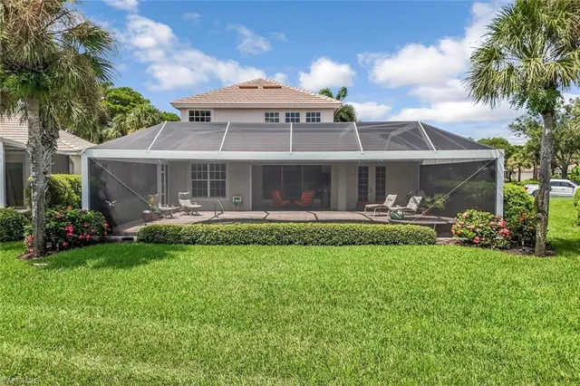a front view of a house with a yard table and chairs