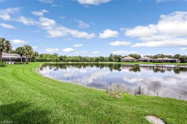 a view of a lake with houses in the back