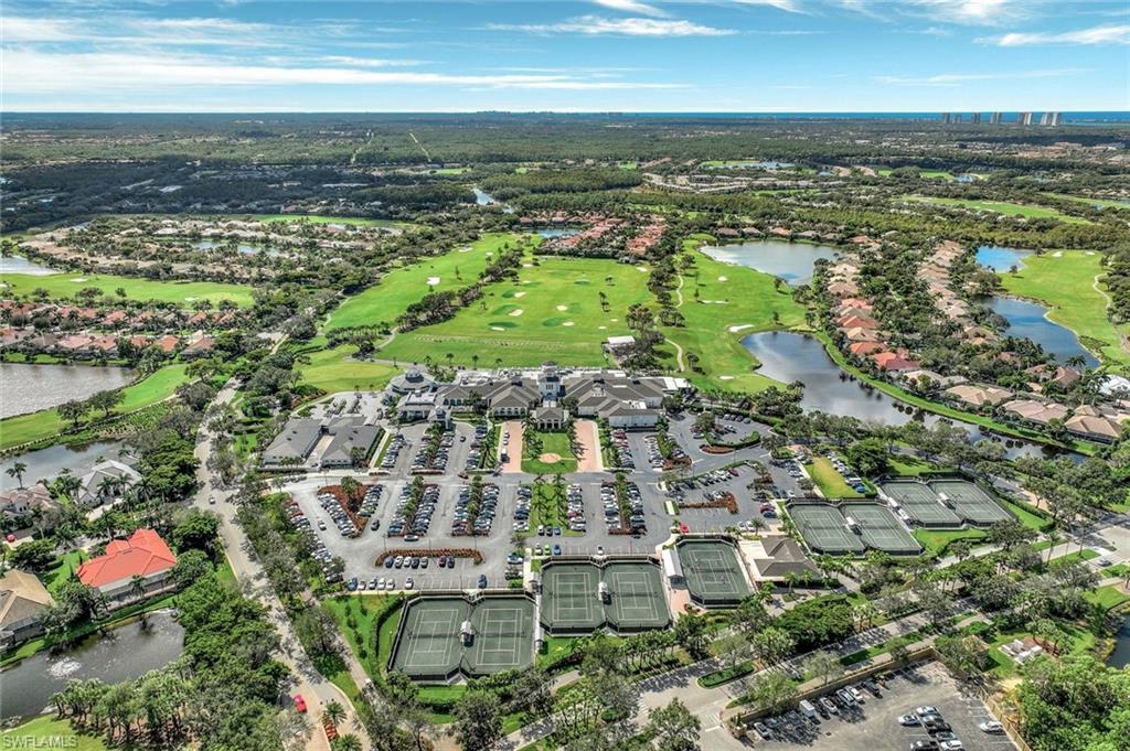 23045 Tree Crest Court Estero, FL 34135 - Photo 41 of 46 Aerial view of property's location with a large body of water, a golf club, and nearby suburban area