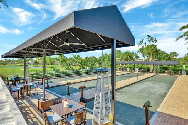 a patio with water view fountain and a backyard