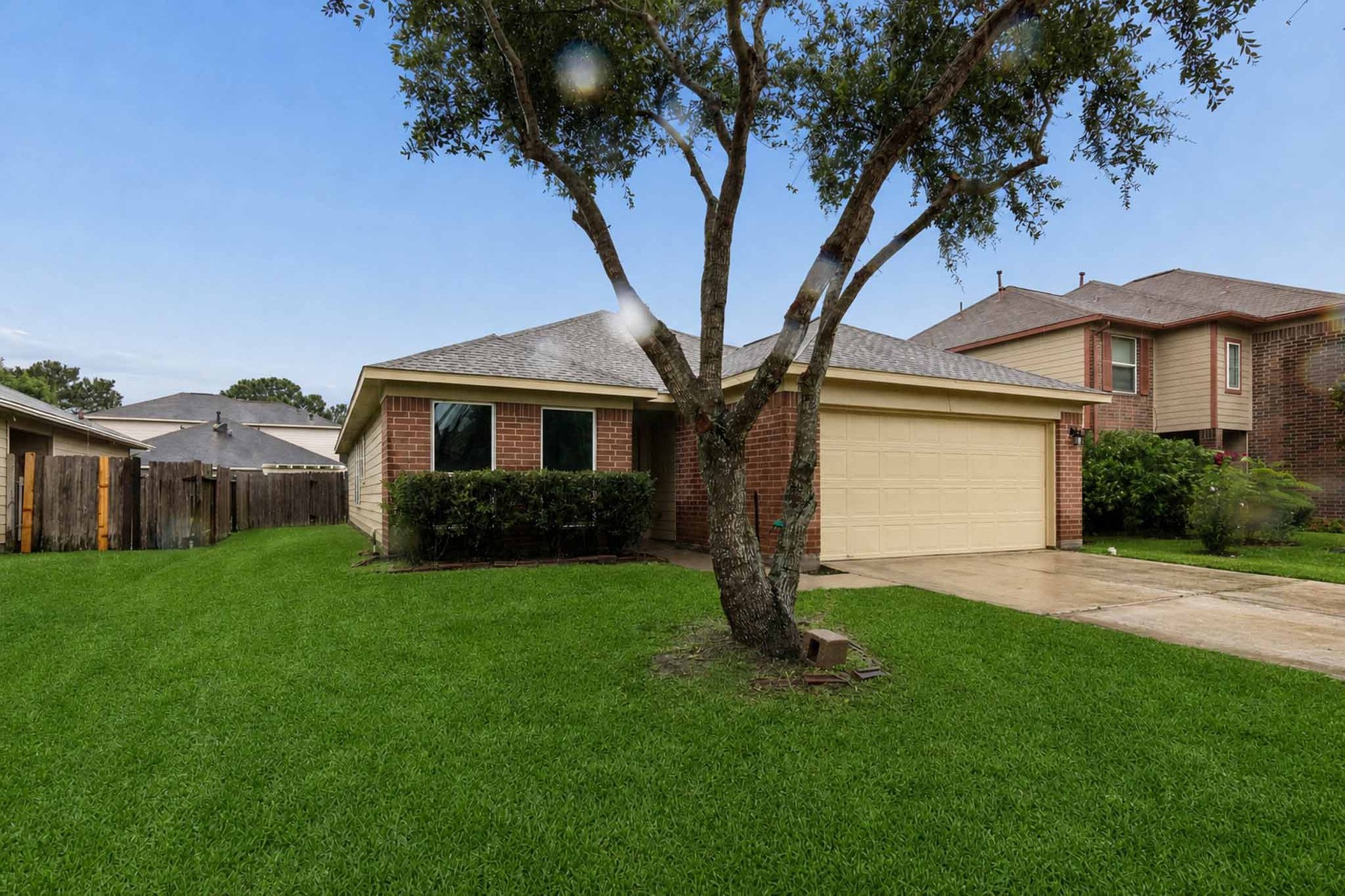 7811 Adonis Avenue Baytown, TX 77521 - Photo 5 of 36 a front view of a house with a garden and yard
