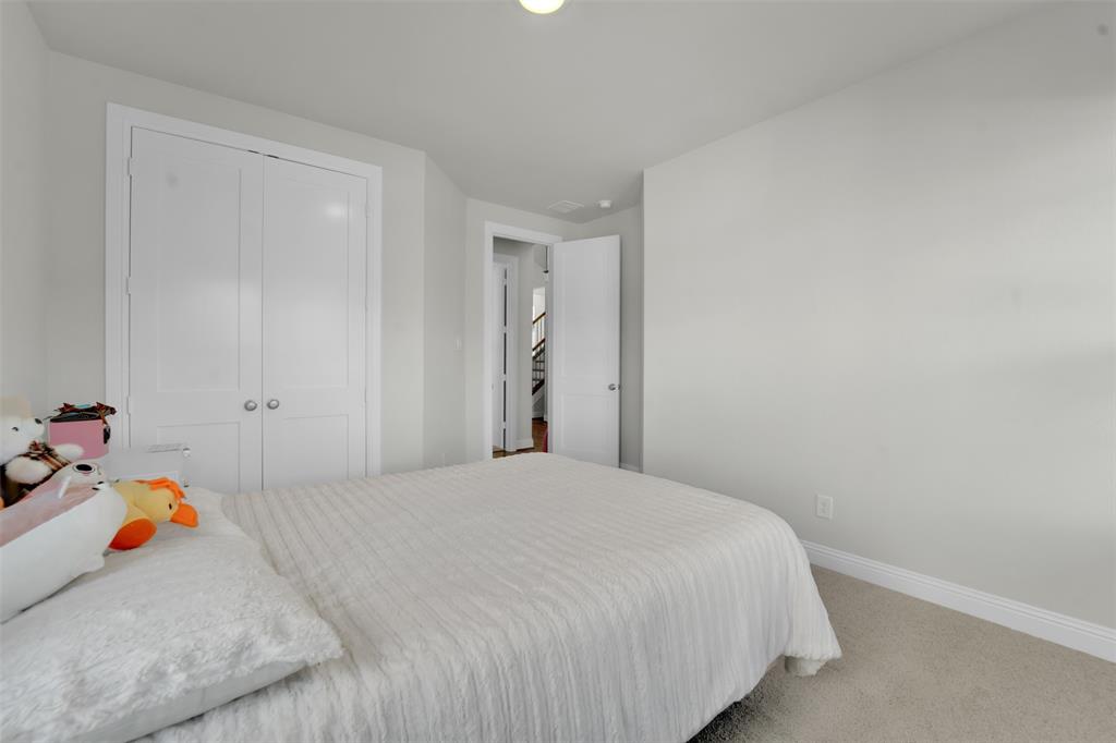3520 Helios Lane Corinth, TX 76208 - Photo 22 of 37 Bedroom featuring light gray walls, white trim, and light beige carpeting