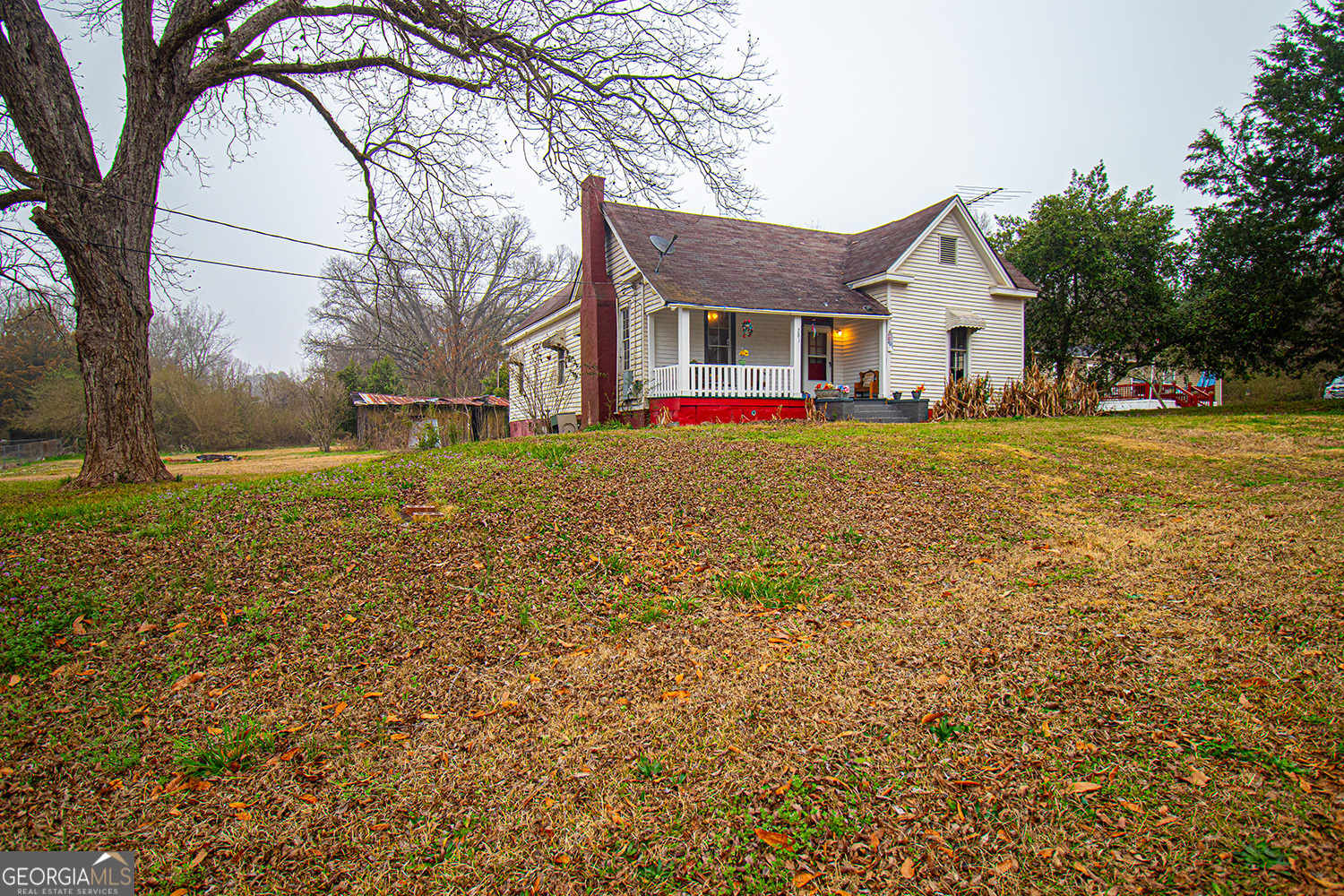 a front view of house with yard and trees