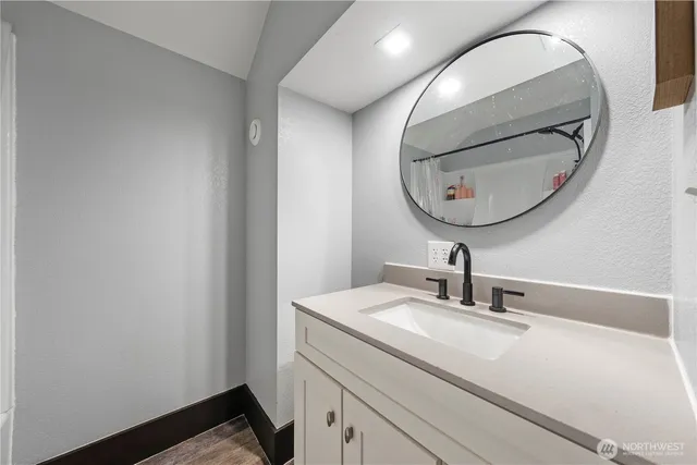 a bathroom with a sink and a mirror