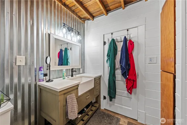 a bathroom with a sink vanity and a mirror