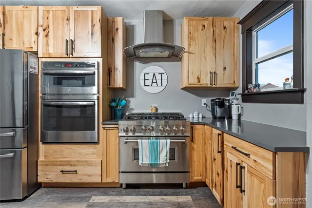 a kitchen with stainless steel appliances granite countertop a stove and a refrigerator