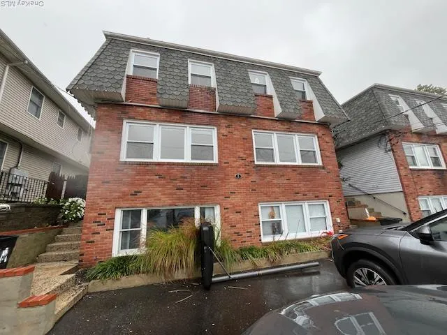 a front view of a house with parking space