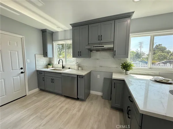a kitchen with a sink stove and cabinets
