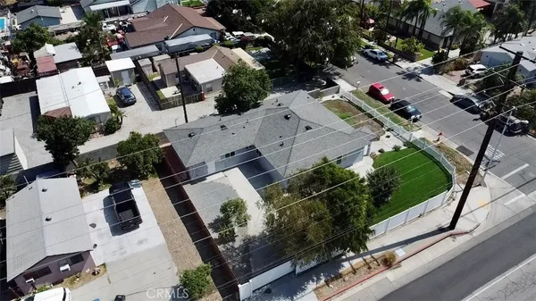 an aerial view of a house with garden space and street view