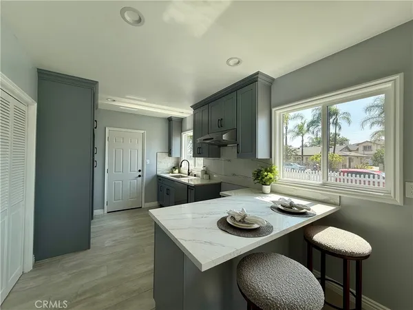 a kitchen with a table chairs stove and refrigerator