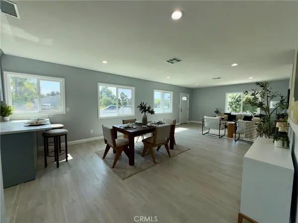 a view of a dining room with furniture and wooden floor