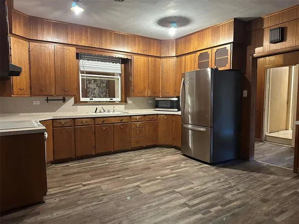 a kitchen with stainless steel appliances granite countertop a refrigerator and a sink