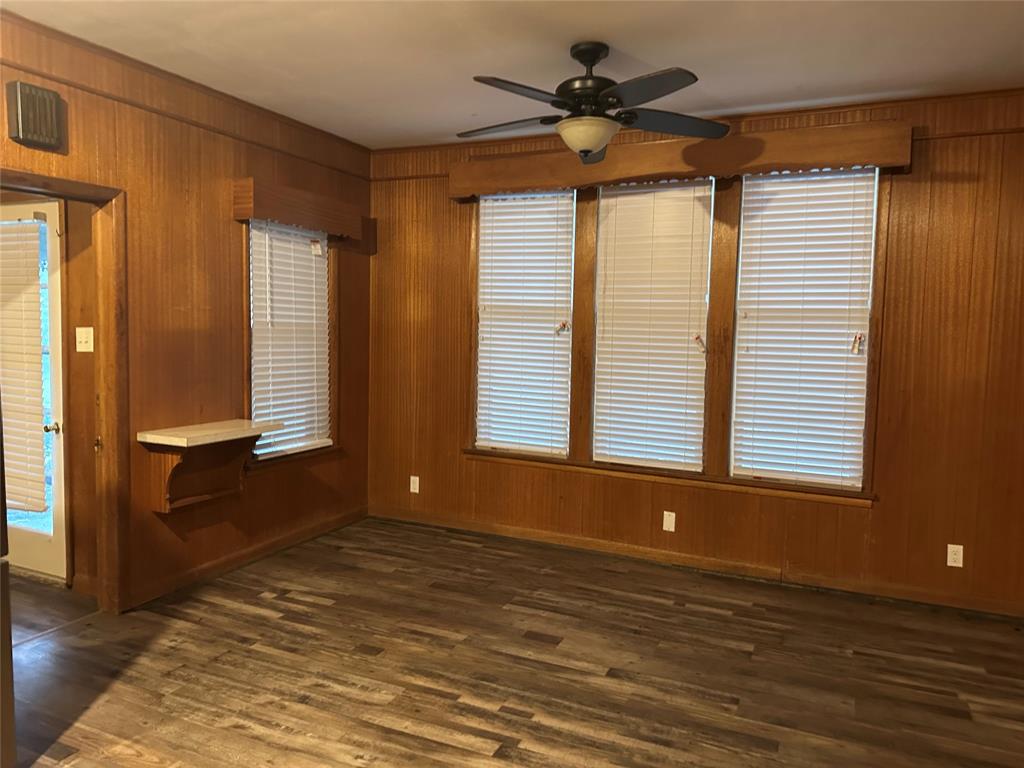 604 Harrel Avenue Bynum, TX 76631 - Photo 13 of 24 a view of an empty room with a window and wooden floor