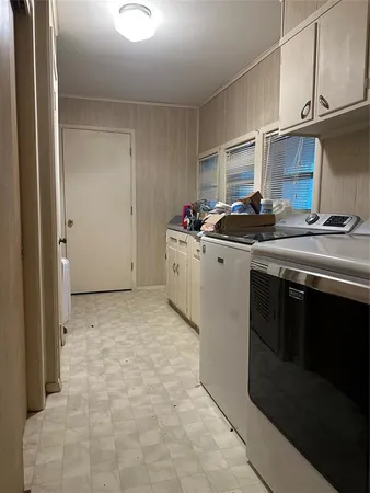 a kitchen with a stove top oven and cabinets