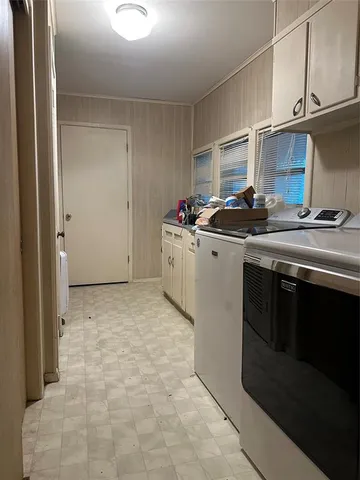 a kitchen with a stove top oven and cabinets