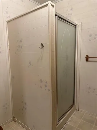a bathroom with a glass shower door