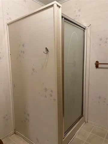a bathroom with a glass shower door