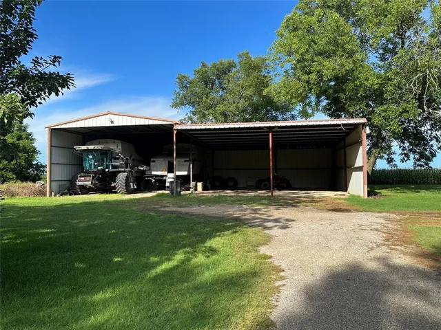 a view of a back yard of the house with green space