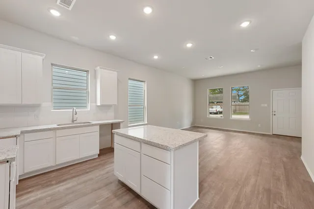 a spacious bathroom with a granite countertop sink and a large mirror