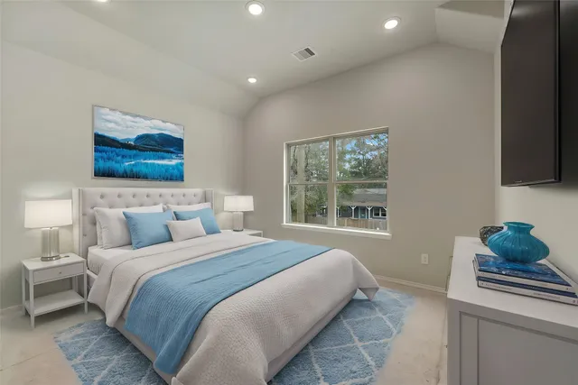 a bedroom with a bed and a window