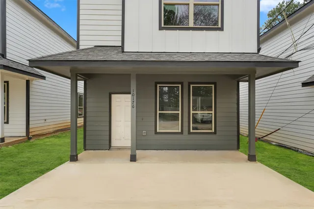 a view of a brick house with a large windows