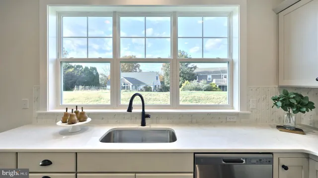 a kitchen with a sink and large window