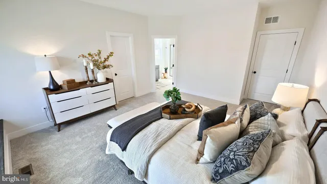 a bed room with a bed and a chair