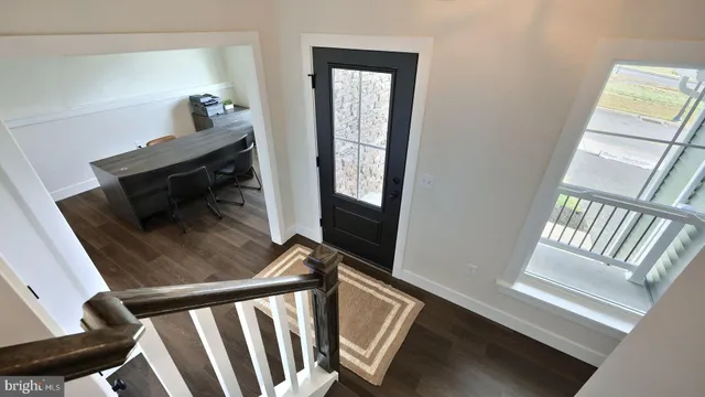 a view of an entryway with wooden floor