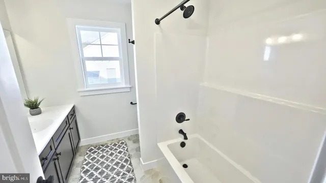 a bathroom with a bathtub and shower