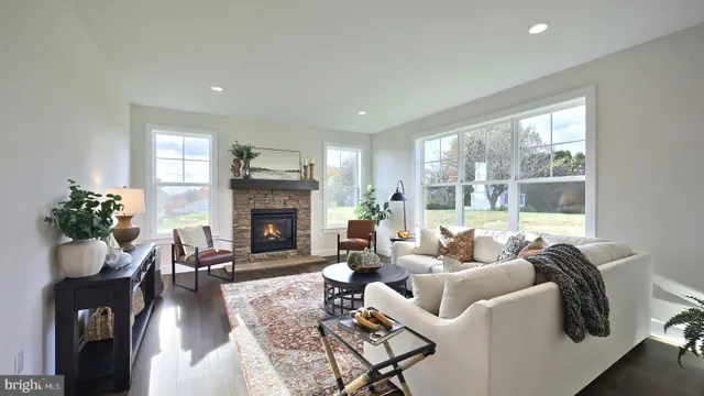 a living room with furniture fireplace and window