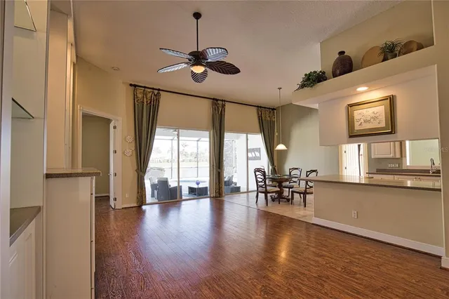 a view of a livingroom with furniture window wooden floor and chandelier